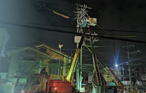 Meralco employees working on pole relocation