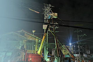 Meralco employees working on pole relocation