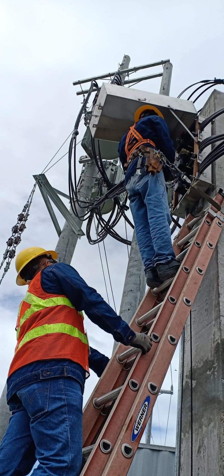 Meralco linemen working on power lines to power vaccination storage facilities